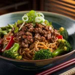Steaming bowl of Healthy Beef Ramen Noodles Stir Fry with colorful vegetables and garnishes