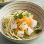 Fresh citrus ceviche with fennel slaw in white bowl