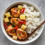 Crockpot Sweet Hawaiian Pineapple Chicken with tender chicken chunks, pineapple, red peppers in tangy sauce, served with white rice.