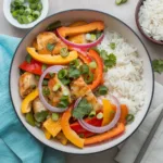 Tropical Chicken and Papaya Stir-Fry with Coconut Rice: colorful dish featuring chicken, papaya, bell peppers, and fluffy rice.
